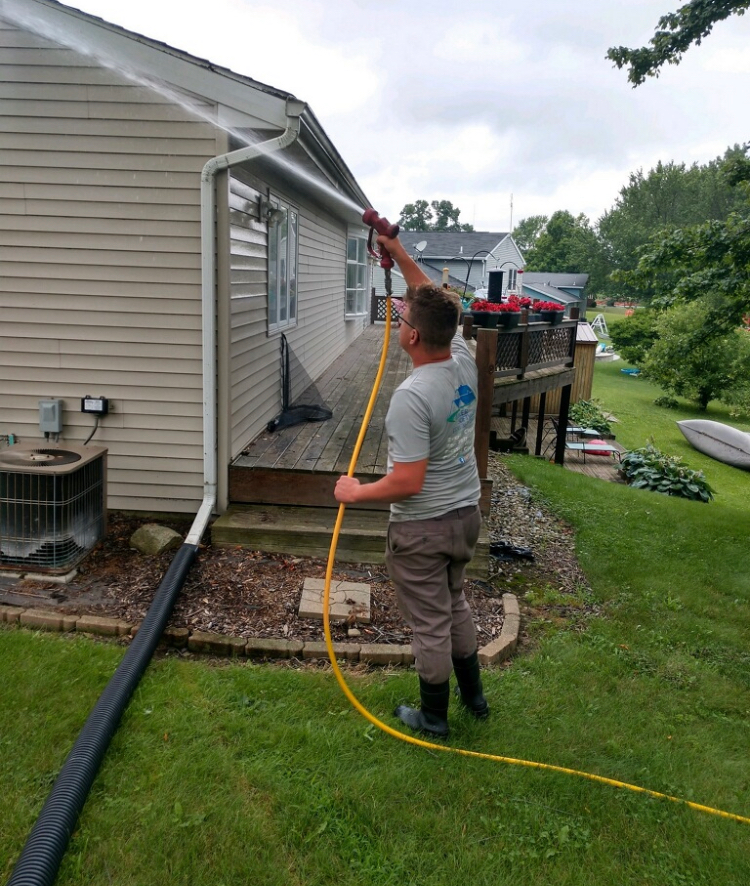 Kenneth Miller soft washing a house for Northern Indiana Power Wash