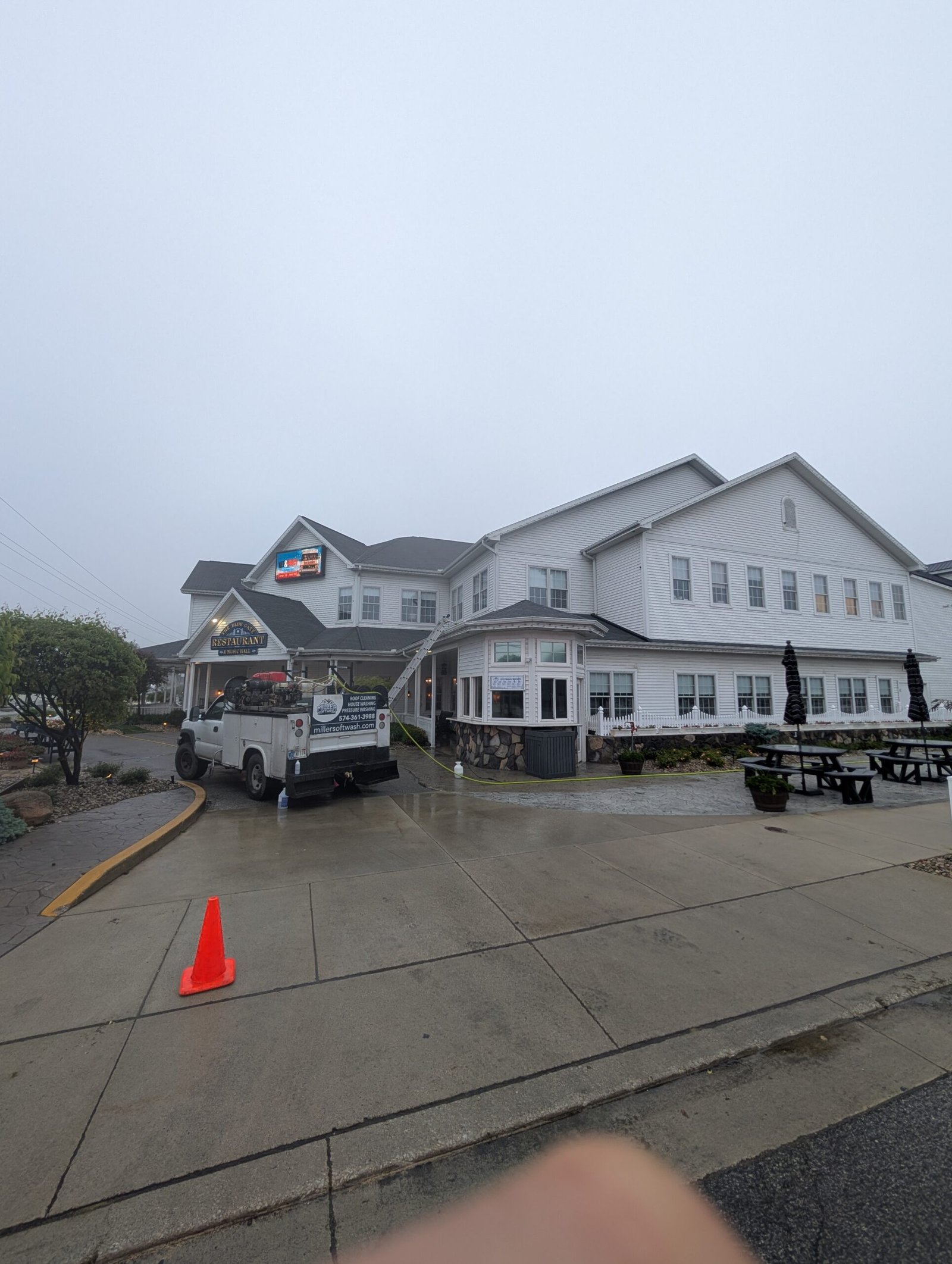 the pressure washing rig sitting in front of the blue gate